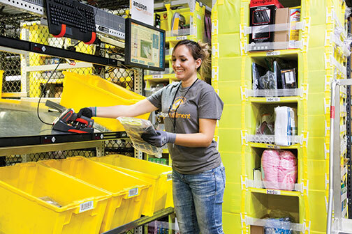An employee at one of Amazon’s 11 fulfillment centers in Kentucky completes an order. 