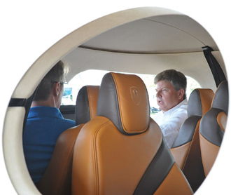 Kestrel CEO Alan Klapmeier, right, sits in the cockpit of a mock-up of the K-350 plane.                                                  