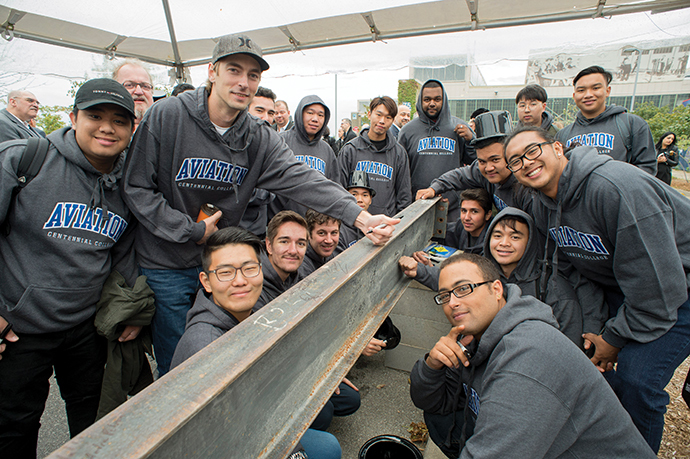 Centennial College is relocating its aviation programs to the Downsview Aerospace Innovation & Research (DAIR) hub. Students recently signed a beam going into the new complex.